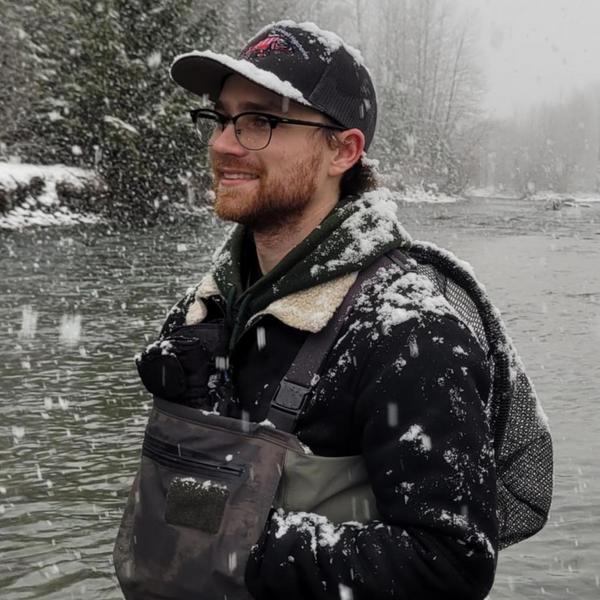 Student standing by a stream