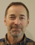 man with short dark hair and short beard