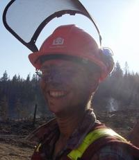 person wearing hard hat with fire ash on their face